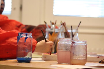 children with brushes. Children paint with paint.