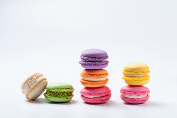 Studio photo of a stack of macarons with different colours isolated on white background