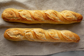 Homemade French Bread Baguette on a gray background, top view.