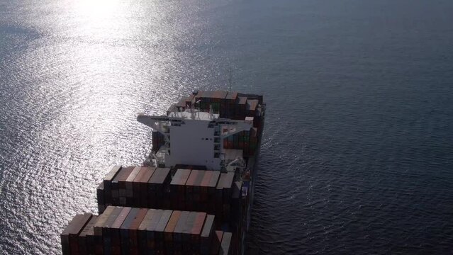 Pacific Ocean - 03.05.2023: Aerial view from drone of ultra large container ship CMA CGM drifting on open sea awaiting for port enter with big quantity of containers on board