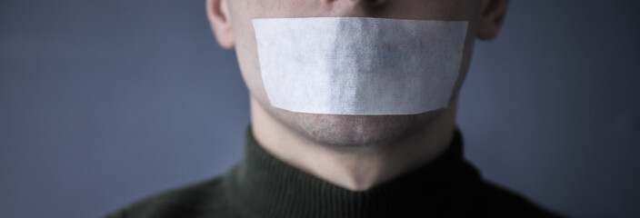 man with duct tape on mouth