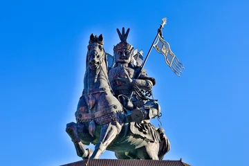 Tuinposter Himalaya A majestic bronze statue of King Gesar, the legendary hero of Tibetan folklore, stands tall against the backdrop of a serene blue sky in Gyegu Town, Yushu, Tibet.