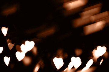 Blurry lights on a dark background. Festive bokeh background in the form of hearts for Valentine's...