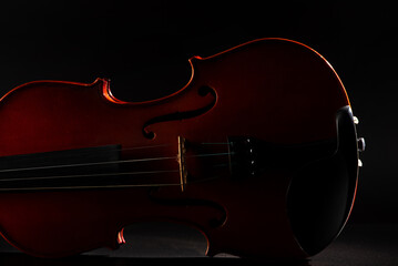 Violin and smoke, wonderful details of a beautiful violin with smoke in the environment, dark background, selective focus.
