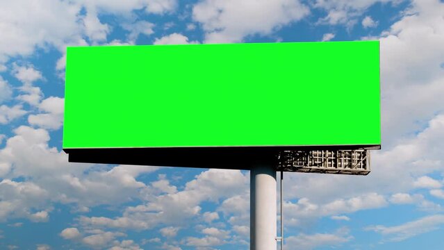 Timelapse: blank green billboard or large display and moving white clouds in the blue sky. Green screen, template, time lapse, copy space, mock up and outdoor advertising concept