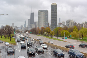 Commuter traffic on a four lane highway running through downtown Chicago  on a rainy spring day