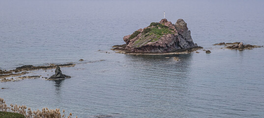 View of a tiny rocky island in Chrysochou Bay at the foot of Aphrodite Nature Trail start, Akamas...