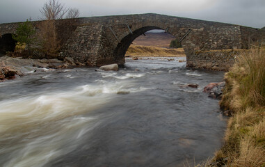 Fototapeta na wymiar Slow shutter release of a fast flowing river in the highlands of Scotland