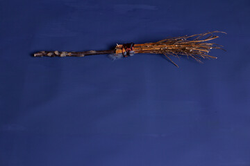 Halloween witch's broom on a blue background
