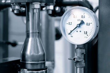 Pipes and taps in water supply boiler room, engineering industrial background
