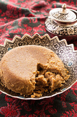 Traditional Arabic sweet halava cake offered as close-up in a classic bowl
