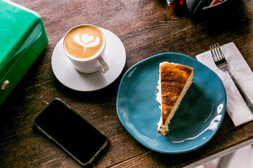 A slice of cake and coffee on a wooden table