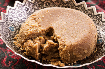 Traditional Arabic sweet halava cake offered as close-up in a classic bowl