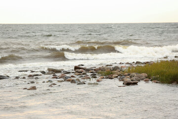 The sea splashes against the stones. The concept of sea rest, relaxation. Waves run onto the shore