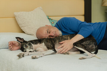 Elderly Man Napping with His Greyhound