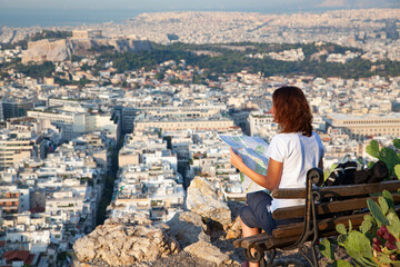 Fototapeta na wymiar woman tourist with map overlooking Athens