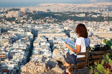 Fototapeta na wymiar woman tourist with map overlooking Athens