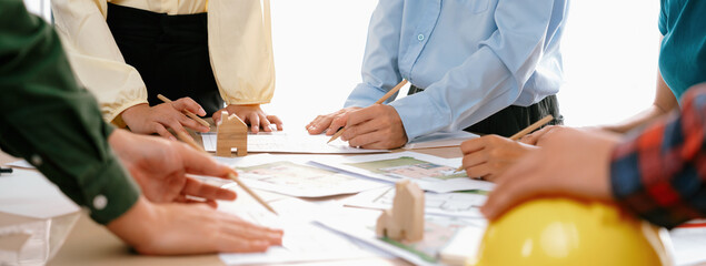 Professional architect team and engineer discuss about architectural project on meeting table with...