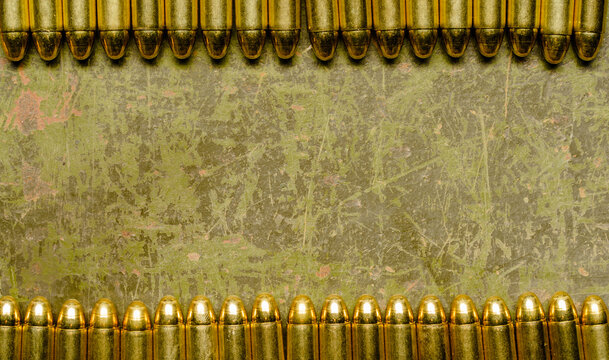 A line of spent bullet casings is displayed against a gritty and worn background, showcasing the aftermath of gunfire.