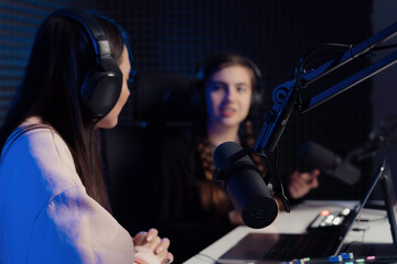 Female host and guest engrossed in an in-depth discussion, providing a glimpse into the focused and...