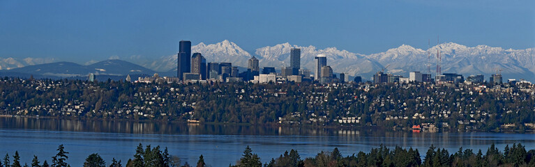 Fototapeta premium Seattle panorama cityscape as seen from the eastside with the Olympic mountains in the background and Lake Washington in the foreground on a beautiful winter day, 20240216_four shot panorama.