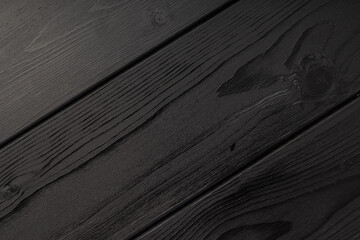 Dark wooden table background with a natural pattern and a knot in the wood.