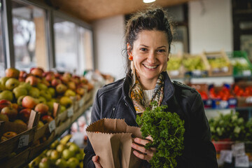 Portrait of one woman hold organic fruit and vegetables in paper bag