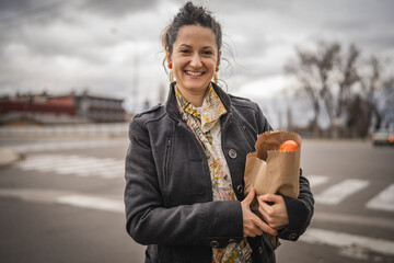 Portrait of one woman hold organic fruit and vegetables in paper bag