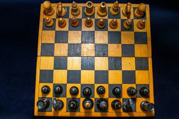 Chess pieces are placed at the beginning of the game on a black background	
