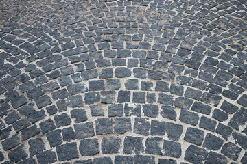 Fototapeta premium Curved paving stone pattern. Aged street background.
