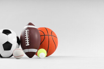 Many different sports balls on light gray background, space for text