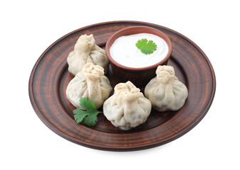 Tasty khinkali (dumplings) with sauce and spices isolated on white. Georgian cuisine