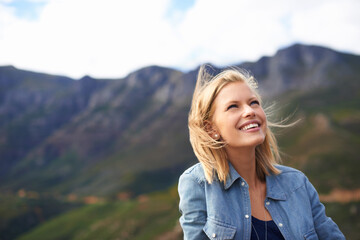 Woman, smile and vacation in nature for mountain as tourist in Cape Town to relax and peace. Female person, happiness and excited for adventure on road trip for holiday, getaway and freedom outdoor
