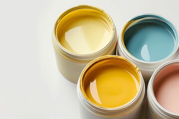 Several containers of wall paint rest on a white surface, displaying a range of vibrant colors and soft nuances. Containers of richly colored paints.