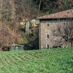 Ancient mill along a small and narrow valley with a waterfall next to it, in the Bolognese countryside. Roncastaldo, Loiano, Bologna, Emilia-Romagna, Italy © GiorgioMorara