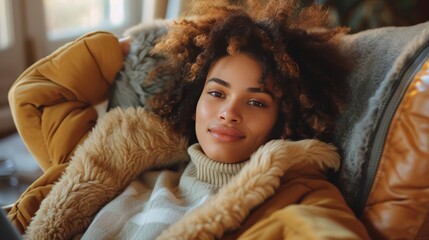A young woman enjoys the comfort of autumn, wrapped in stylish knitted wear and a warm hat, with a relaxed, happy expression.