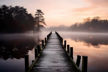 Fotobehang Wooden jetty on a misty morning in autumn, England © gographic