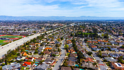 Aerial view of typical single family residential neighborhood in Cupertino, California next to interstate highway 280