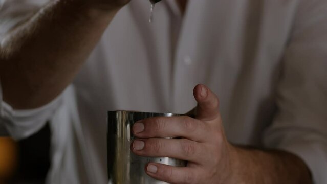 Bartender opening up a cocktail shaker