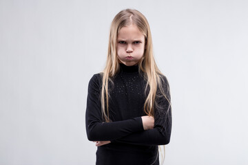 Child's pout and posture spell stubborn discontent - obrazy, fototapety, plakaty