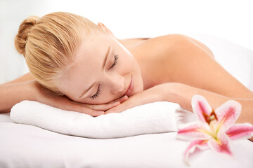 Obraz na płótnie Canvas Relax, sleep and woman at spa with flower for luxury holistic treatment, facial health and professional massage therapy. Self care, peace and refresh for girl on bed in natural rest for body wellness
