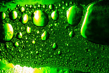 green macro bubble texture,Light Green Background Closeup of Oil Drops in Water. Abstract Macro Photo of Liquid Surface with Bubbles. Bright Design of Structural Watery Texture.