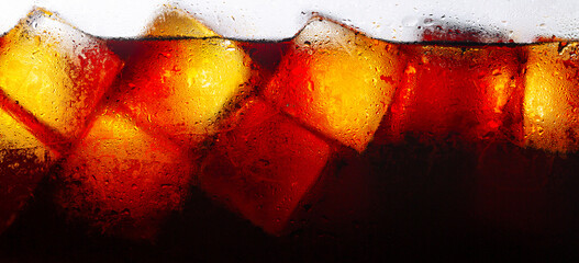 Crola and ice surface,Close up of the ice cubes in cola water. Texture of carbonate drink with...