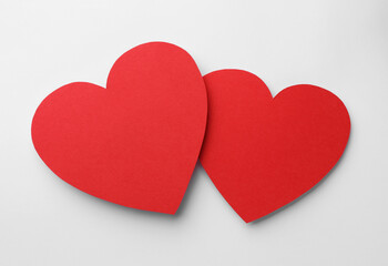 Fototapeta premium Paper hearts on white background, top view