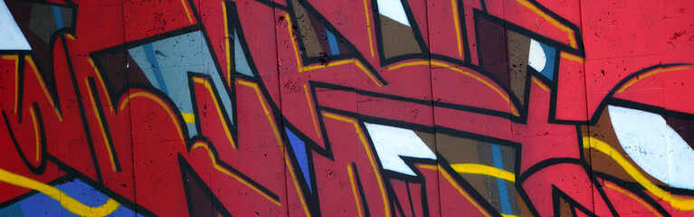 Colorful background of graffiti painting artwork with bright aerosol outlines on wall. Old school...