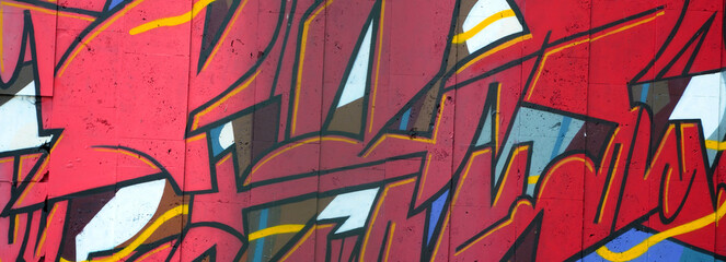 Colorful background of graffiti painting artwork with bright aerosol outlines on wall. Old school...