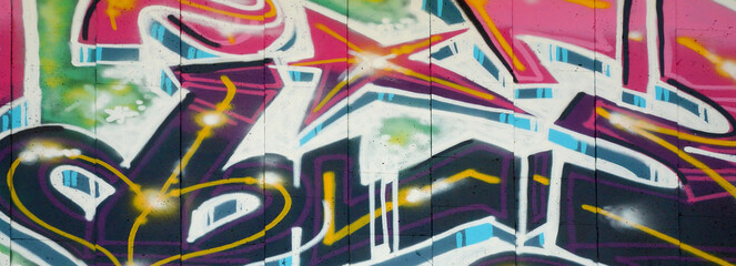 Colorful background of graffiti painting artwork with bright aerosol outlines on wall. Old school...