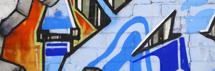 Colorful background of graffiti painting artwork with bright aerosol outlines on wall. Old school...