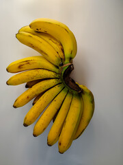 one combed banana that is ripe on a white background