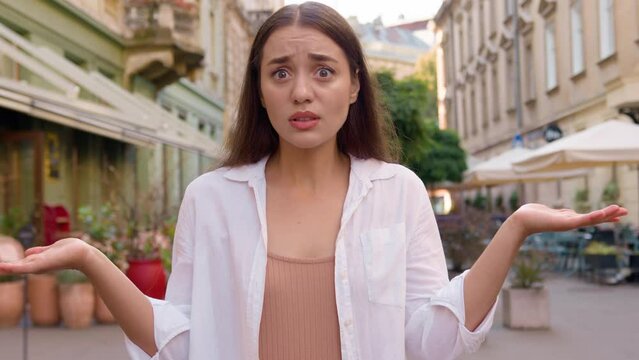 Caucasian european woman upset late time arms crossed showing hand watch angry displeased girl city street outside annoyed gen z wait lack of punctuality dissatisfied client delivery courier service